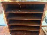 a wooden shelf with a laptop on top of it