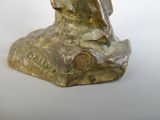 a statue of a bird sitting on a rock