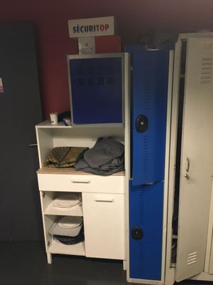 two lockers in a room with a computer on top of them