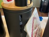 a black trash can sitting on top of a counter next to a black trash can