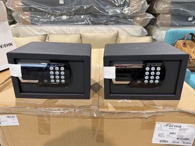 deux coffres-forts électroniques posés sur une boîte en carton