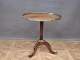 an image of a small table with a wooden top on a wooden floor