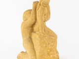 an image of a statue of a woman sitting on a rock