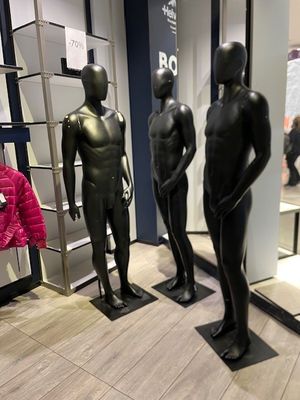 three mannequins that are on display in a store