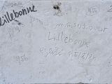 a sign on the side of a building that has writing on it