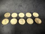 a bunch of gold coins sitting on top of a black surface