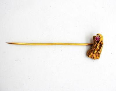 an image of a gold stick with a pink stone in the middle
