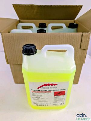 un gros plan sur une bouteille de liquide à côté d'une boîte en carton