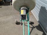 an image of a cement mixer in front of a garage