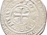 une vieille pièce d'argent ornée d'une croix