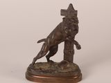 bronze statue of a dog with a crown on its head