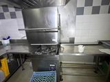 a kitchen with a stove, sink, oven, and other appliances
