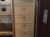 a wooden cabinet with a mirror on top of it