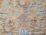a large oriental rug with blue and gold designs on it