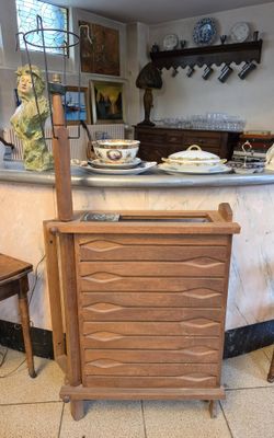 a wooden cabinet sitting in the middle of a kitchen
