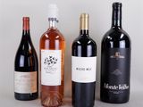 several bottles of wine are lined up on a table