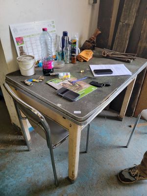 a table that has a laptop on it and a cell phone on it