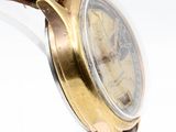 a close up of a wrist watch with a brown strap