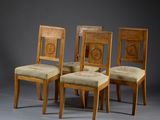 three wooden chairs with beige upholstered seats and a beige upholstered seat
