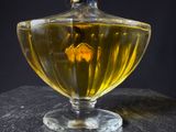 a glass jar with a flower inside of it on a table