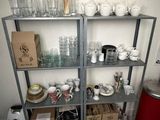 many cups and glasses on the shelves in the kitchen