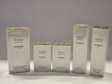 three bottles of chanel perfume sitting next to each other on a table