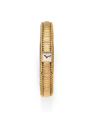 a gold bracelet watch with a white dial on a white background