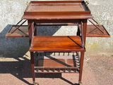 a small wooden table with two shelves on it