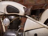 a close up of a motorcycle parked in front of a brick wall