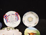 four plates with different designs on them on a black surface