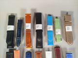 a lot of different colored leather watches on the table