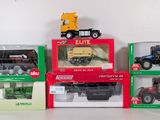 four different models of tractors in boxes on a table