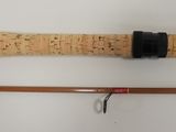 two different types of fishing rods on a white surface