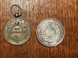 two coins that are sitting next to each other on a table