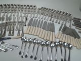 a lot of forks and spoons that are on the table