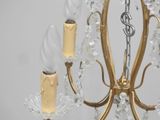 a gold chandelier with crystal beads hanging from it