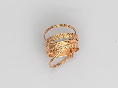a close up of a gold ring on a white surface