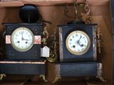 two clocks that are sitting in a box together