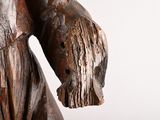 a wooden statue of a man with a hat on