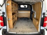 a white van with wooden shelves in the back of it