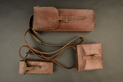 three pieces of leather luggage sitting next to each other on a table