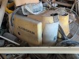 a pile of junk in a garage with a lot of tools