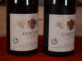 two bottles of wine sitting next to each other on a table