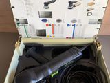 a box with a corded sander in it sitting on top of a table