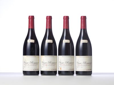 three bottles of red wine are lined up on a table