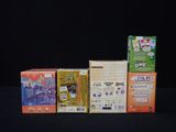 a lot of different kinds of cereal boxes on a black table