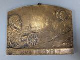 an image of a metal plaque with an image of a man on a horse drawn carriage
