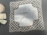 a white doily and a pair of scissors on a table