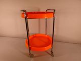 an orange trolley that is sitting on a white surface