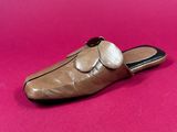 a close up of a pair of shoes on a pink surface